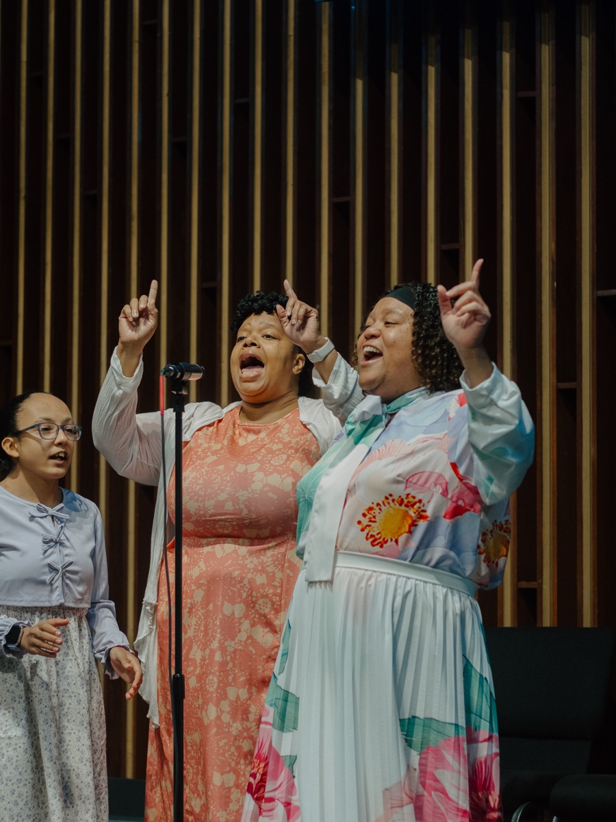 Three women of Greater Faith singing together