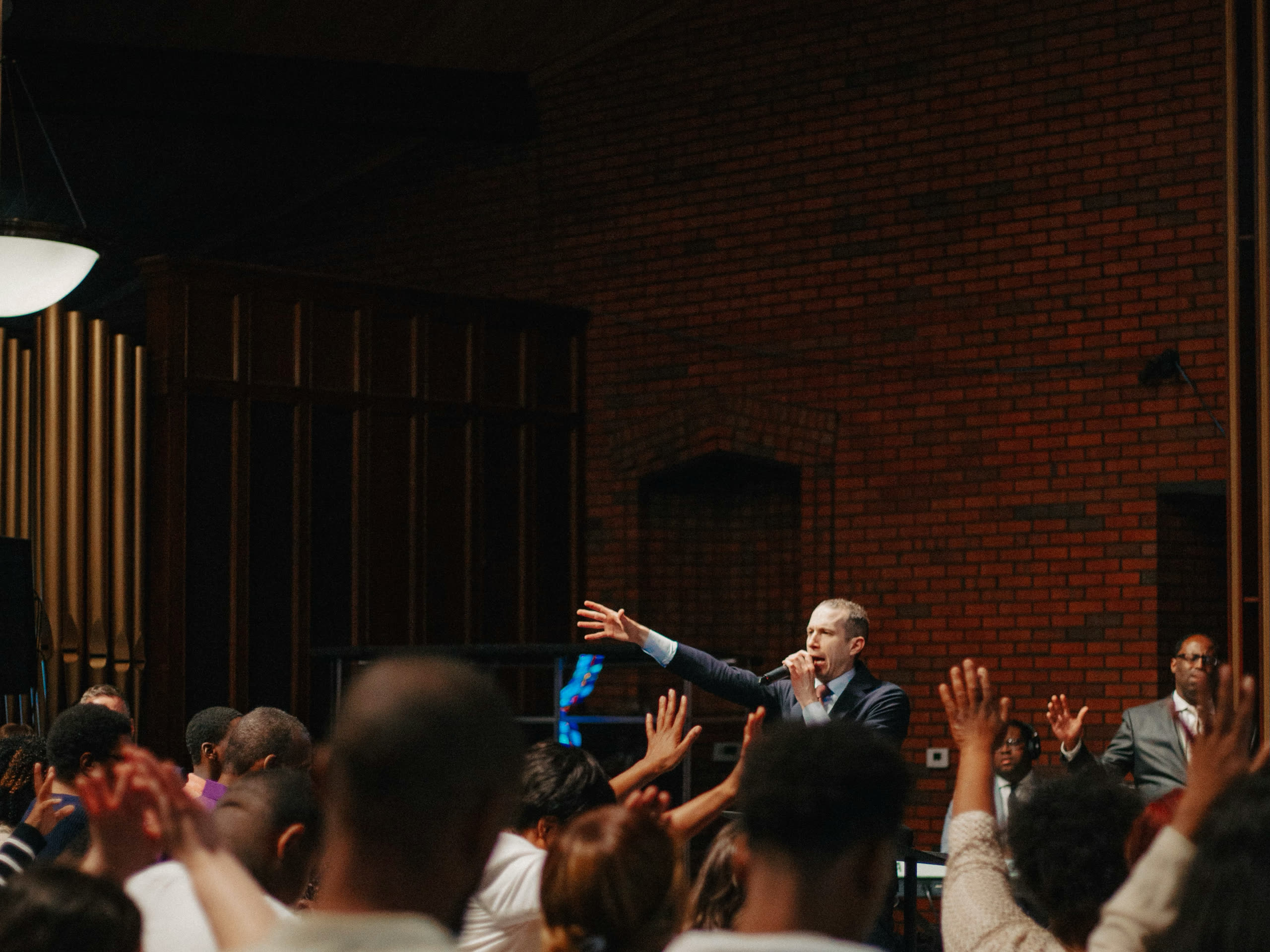 The Greater Faith sanctuary packed for an altar call, hands raised across the room