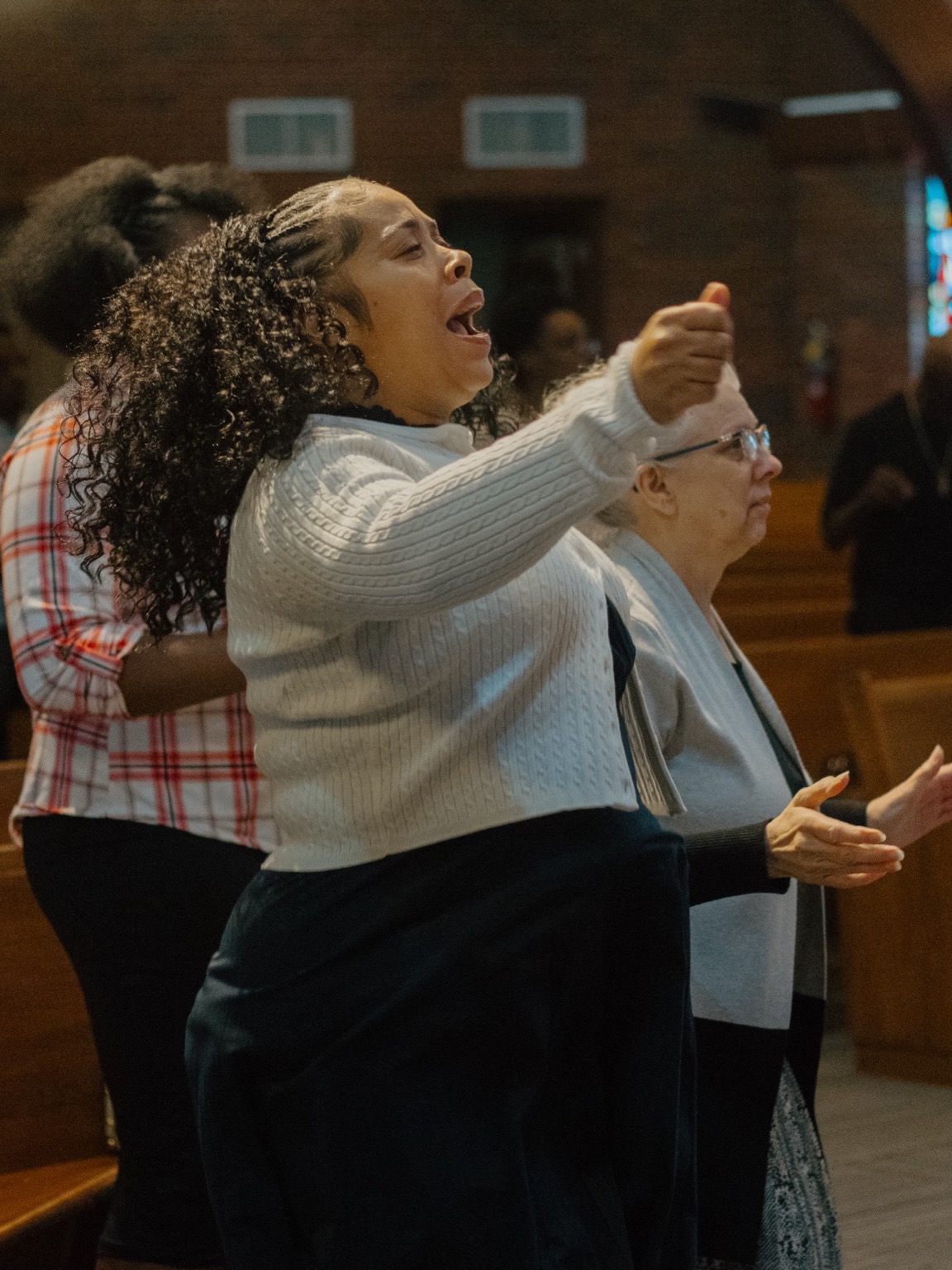 A couple clapping in the pews at Greater Faith