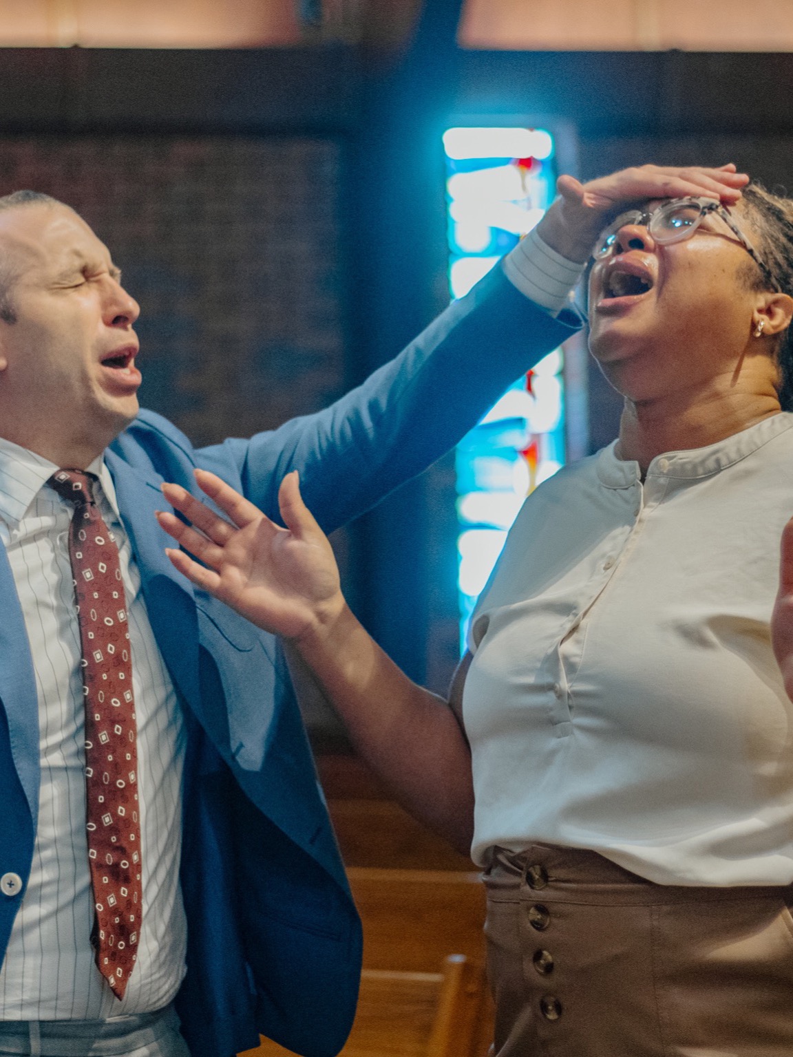 A woman moved to tears during altar prayer at Greater Faith