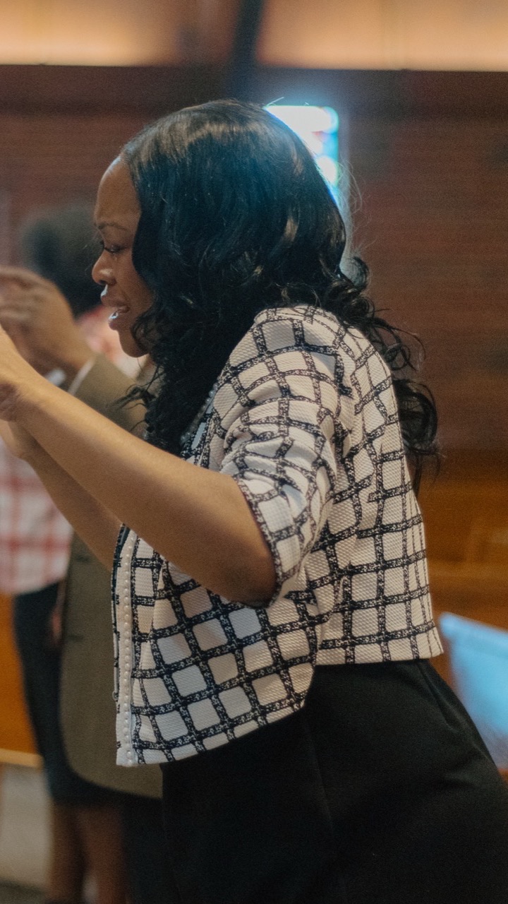 A woman worshiping in the pews