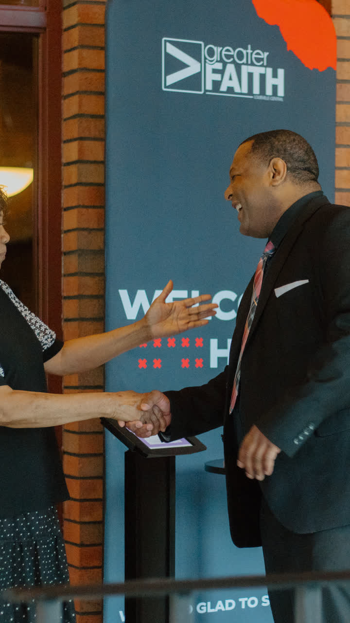 A handshake at the welcome banner